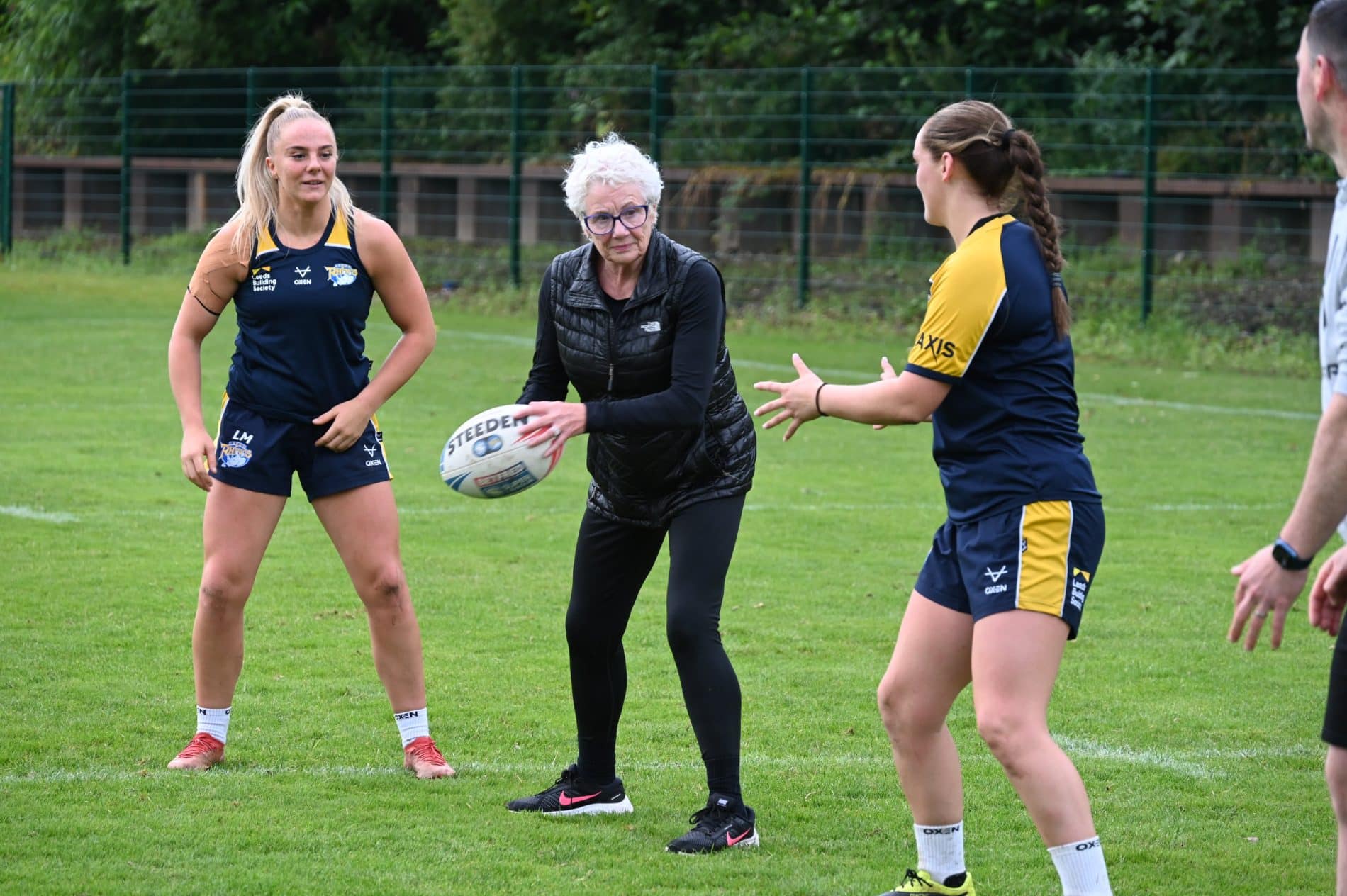 Sponsors of the Leeds Rhinos Women’s team were invited to the Bartercard Training Complex at Kirkstall for the annual training session with the team.
They got the opportunity to watch the team prepare for their next game against Barrow before joining in some skills sessions with the team. Caitlin Casey tested their kicking skills with a cross-bar challenge, Bella Sykes and Shannon Lacey led on passing skills and Keara Bennett and Bethan Dainton got the sponsors involved with some walking rugby.